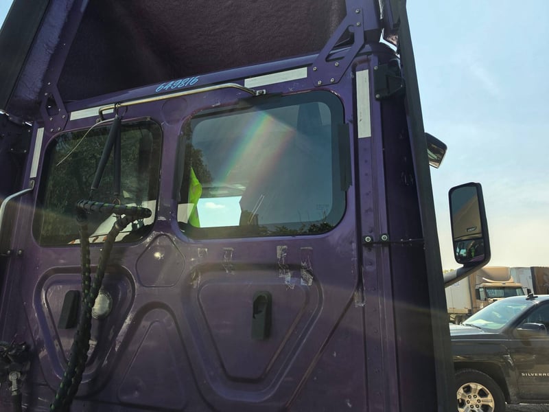 The same semi truck cab with new driver-side door glass installed